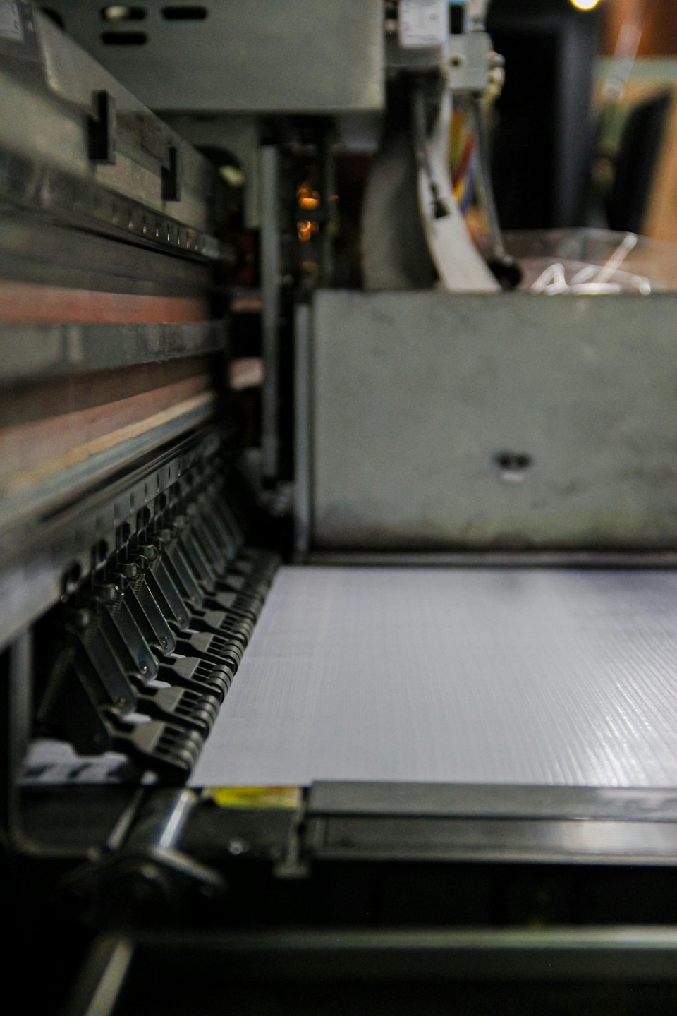 Industrial large-format printer print head assembly over material.